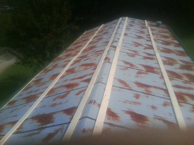 Rusted metal roof panels with new wood purlins before replacement — Storm Damage Roof Repair in Limington by Roofing Brothers